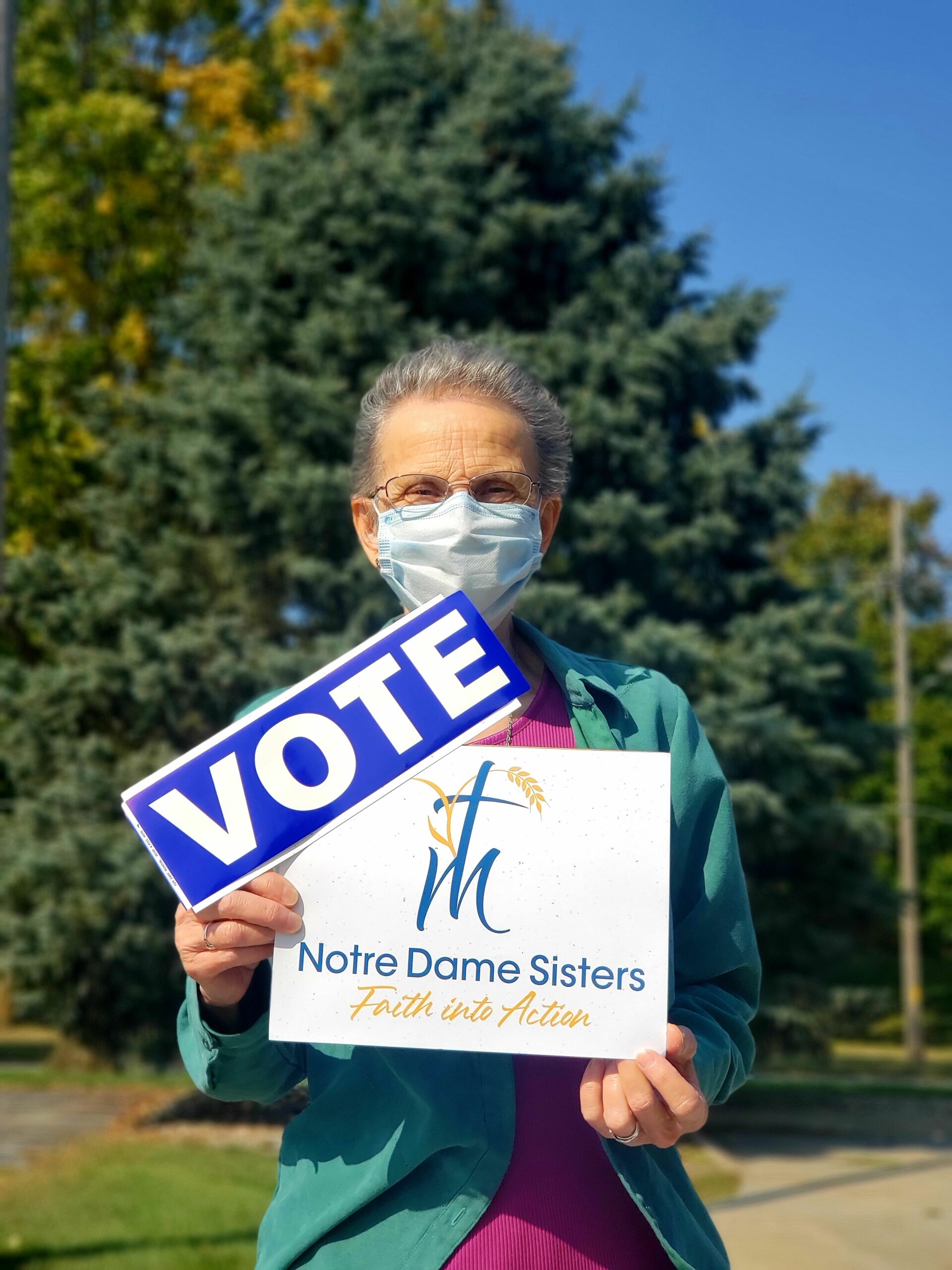sister holding signs to promote nds and voting
